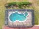 An aerial view of a screened-in pool and spa at 304 Sorrento Road, Poinciana, FL 34759