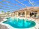 Inviting pool area with covered patio and spa at 304 Sorrento Road, Poinciana, FL 34759