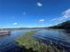 Peaceful lakefront property with a pontoon boat at 3306 Sagebrush St, Harmony, FL 34773