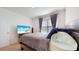 Well-lit bedroom with a queen-size bed and TV at 5109 Barombi Bnd, Saint Cloud, FL 34772