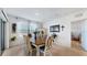 Dining room with a wooden table and six chairs and view of a bedroom at 5109 Barombi Bnd, Saint Cloud, FL 34772