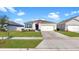 One-story house featuring a two-car garage and manicured lawn at 5109 Barombi Bnd, Saint Cloud, FL 34772