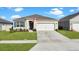 One-story home with two-car garage and landscaped lawn at 5109 Barombi Bnd, Saint Cloud, FL 34772