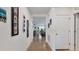 A long hallway with pictures on the wall and view of Gathering room at 5109 Barombi Bnd, Saint Cloud, FL 34772