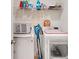 Convenient laundry room with washer, dryer, and shelving at 5109 Barombi Bnd, Saint Cloud, FL 34772