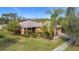 Single story house with a large yard and palm trees at 512 Heartwell Dr, Poinciana, FL 34759