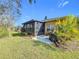 Landscaped backyard with screened patio and grill at 512 Heartwell Dr, Poinciana, FL 34759