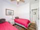 Bright bedroom with two twin beds, dresser, and hardwood floors at 512 Heartwell Dr, Poinciana, FL 34759