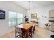 Dining area with a wooden table and chairs, near the kitchen at 512 Heartwell Dr, Poinciana, FL 34759
