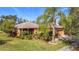Single-story house with landscaped yard, screened porch, and attached garage at 512 Heartwell Dr, Poinciana, FL 34759