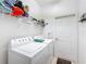 Laundry room with washer, dryer, and shelving at 512 Heartwell Dr, Poinciana, FL 34759