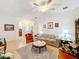 Bright living room with comfortable furniture and a view to the sunroom at 512 Heartwell Dr, Poinciana, FL 34759