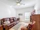 Relaxing living room with leather couch and ceiling fan at 512 Heartwell Dr, Poinciana, FL 34759