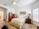 Bright bedroom with a large bed and ceiling fan at 512 Heartwell Dr, Poinciana, FL 34759