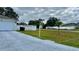 House front yard with driveway and small lawn at 551 Albatross Dr, Poinciana, FL 34759