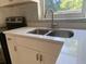 Modern kitchen with white cabinets, quartz countertops, and stainless steel appliances at 907 Columbia St, Orlando, FL 32805