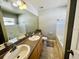 Bathroom with double sinks, granite countertop, and bathtub at 931 Emerald Green Ct, Kissimmee, FL 34746