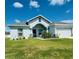 Single-story home with a two-car garage and landscaped lawn at 932 Albertville Ct, Kissimmee, FL 34759
