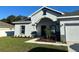 House exterior with two-car garage and landscaping at 932 Albertville Ct, Kissimmee, FL 34759