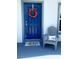 Inviting front entrance with a blue door and decor at 932 Albertville Ct, Kissimmee, FL 34759