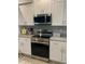 Modern kitchen with stainless steel appliances and granite countertops at 932 Albertville Ct, Kissimmee, FL 34759