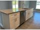 Kitchen island with granite countertop and stainless steel dishwasher at 932 Albertville Ct, Kissimmee, FL 34759