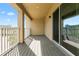 Spacious balcony with gray wood-like flooring and a sliding glass door at 9475 Randal Park Blvd, Orlando, FL 32832