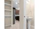 Hallway view towards a half bathroom with modern fixtures and tile floors near the kitchen at 9475 Randal Park Blvd, Orlando, FL 32832