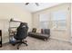 Bedroom with a futon couch, desk, and carpet flooring, suitable as a study or guest room at 9475 Randal Park Blvd, Orlando, FL 32832