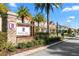 Randal Walk gated community entrance, with palm trees and well-maintained landscaping at 9475 Randal Park Blvd, Orlando, FL 32832