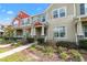 Charming two-story townhome with well-maintained landscaping and inviting front porch at 9475 Randal Park Blvd, Orlando, FL 32832