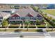 Inviting townhomes featuring manicured landscaping, vibrant colors and a sidewalk with street access at 9475 Randal Park Blvd, Orlando, FL 32832
