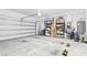 Spacious garage with ample storage shelving and a partially open garage door at 9475 Randal Park Blvd, Orlando, FL 32832