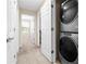 Hallway featuring a stacked washer and dryer and leading to other rooms at 9475 Randal Park Blvd, Orlando, FL 32832