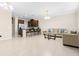 Bright, open living room with tile floors, seamlessly blending with kitchen and bar seating at 9475 Randal Park Blvd, Orlando, FL 32832