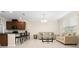 Open-concept living room featuring neutral decor, tile flooring, and seamlessly connected to the kitchen at 9475 Randal Park Blvd, Orlando, FL 32832