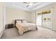 Spacious main bedroom featuring plush carpeting, a tray ceiling, and a sliding door to the balcony at 9475 Randal Park Blvd, Orlando, FL 32832