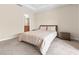 Comfortable main bedroom with soft carpet, neutral walls, and a view into the ensuite bathroom at 9475 Randal Park Blvd, Orlando, FL 32832