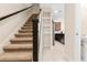 View of the carpeted staircase with dark wood railing leading to the upper level of the home at 9475 Randal Park Blvd, Orlando, FL 32832