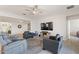 Bright living room showcasing ample seating and built-in shelving at 1311 Moss Creek Ln, Davenport, FL 33836