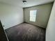 Simple bedroom with carpeted floor and window at 1421 Swift Ct, Poinciana, FL 34759