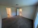 Spacious bedroom with carpet flooring and access to bathroom and kitchen at 1421 Swift Ct, Poinciana, FL 34759