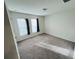 Charming bedroom with carpeted floor and two windows at 1421 Swift Ct, Poinciana, FL 34759