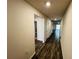 Bright hallway with wood-look floors leading to other rooms at 1421 Swift Ct, Poinciana, FL 34759