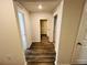 Clean hallway with wood-look flooring at 1421 Swift Ct, Poinciana, FL 34759