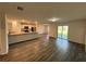 Open-concept kitchen with island and stainless steel appliances at 1421 Swift Ct, Poinciana, FL 34759
