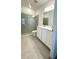 Bathroom with double vanity, large mirror, and walk-in shower at 1625 Hill Park Dr, Deltona, FL 32725