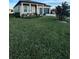 House front with lush green lawn and driveway at 1625 Hill Park Dr, Deltona, FL 32725