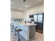 Modern kitchen with white cabinets, stainless steel appliances, and an island at 1625 Hill Park Dr, Deltona, FL 32725