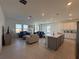 Open living room and kitchen area with tile flooring and comfy furniture at 1625 Hill Park Dr, Deltona, FL 32725